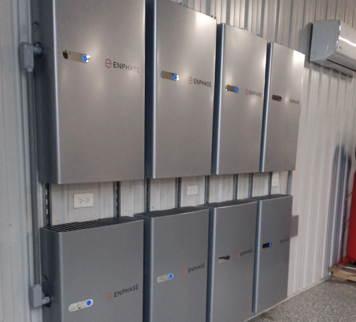 Multiple Enphase battery storage units mounted indoors as part of a solar energy system